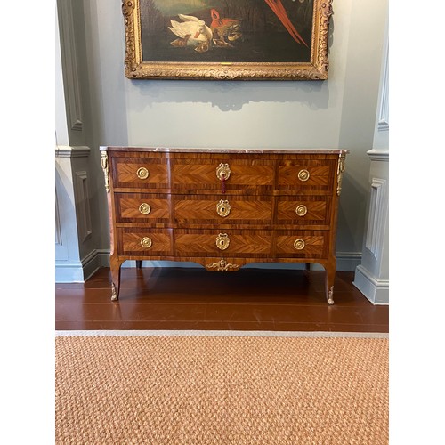 211 - A Louis XV ormolu-mounted kingwood and fruitwood commode with a rouge marble top and three long draw... 