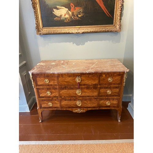 211 - A Louis XV ormolu-mounted kingwood and fruitwood commode with a rouge marble top and three long draw... 