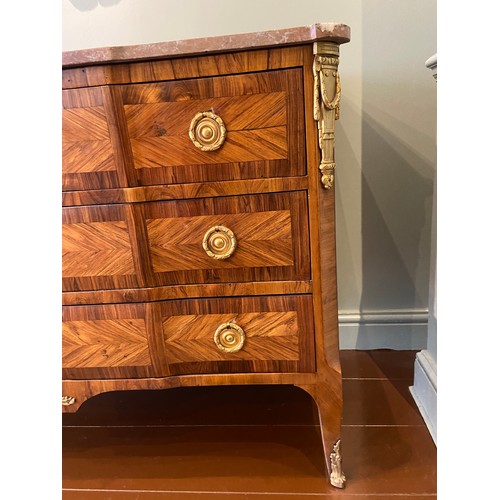 211 - A Louis XV ormolu-mounted kingwood and fruitwood commode with a rouge marble top and three long draw... 