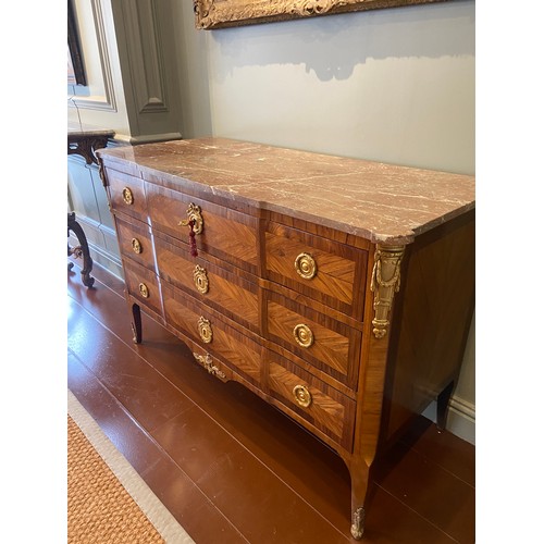 211 - A Louis XV ormolu-mounted kingwood and fruitwood commode with a rouge marble top and three long draw... 