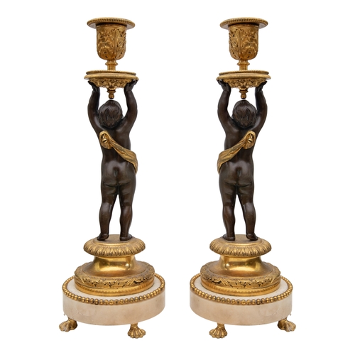 93 - Property of a Gentleman19th CenturyA pair of patinated and gilt bronze and white marble figural cand... 