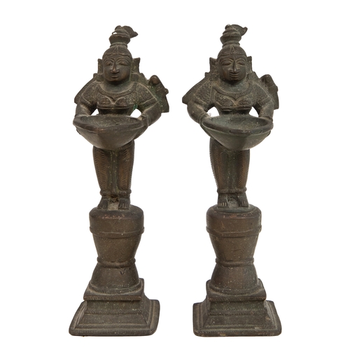 78A - Property of a LadyCentral IndianAntiqueThree bronze votive statues of deitiesA pair holding trays fo... 