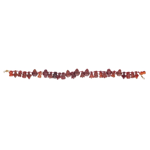 349 - Property of a LadyEgyptianNew Kingdom or laterA carnelian amulet necklace with a variety of Egyptian... 