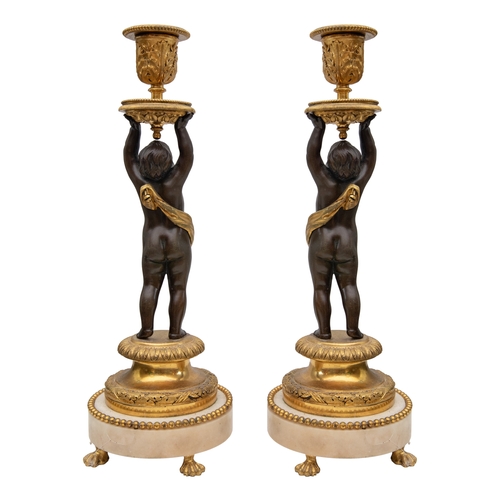 93 - Property of a Gentleman19th CenturyA pair of patinated and gilt bronze and white marble figural cand... 