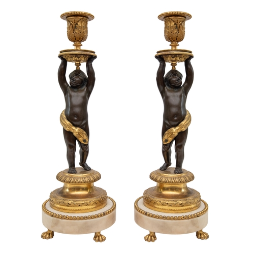 93 - Property of a Gentleman19th CenturyA pair of patinated and gilt bronze and white marble figural cand... 