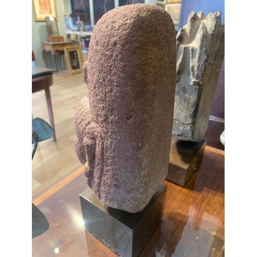 79 - Property of a deceased gentlemanIndian10th - 14th CenturyA red stone Buddha's head, carved in the ro... 