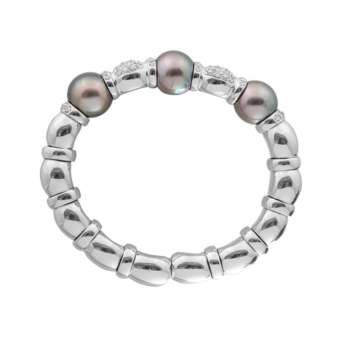 63 - A Tahitian grey pearl and brilliant cut diamond bangleSet to the front with three large cultured pea... 