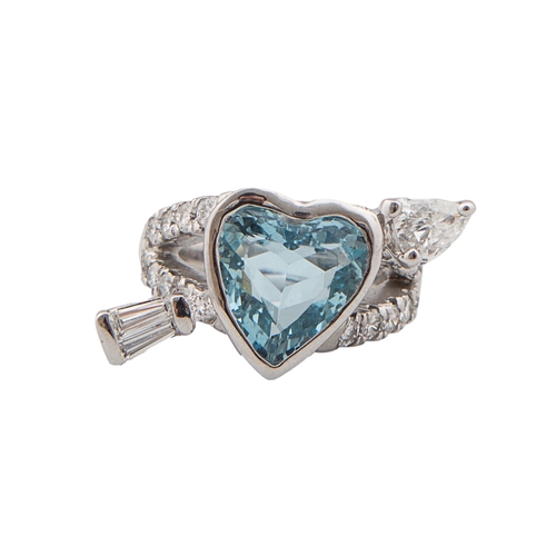 71 - A blue topaz and diamond arrow heart ringThe heart shaped centre with rub over setting with tapered ... 