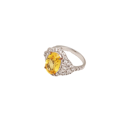 85 - A yellow sapphire and diamond cocktail dress ringThe oval shaped mixed cut yellow sapphire of good c... 