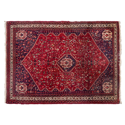 291 - An intricately geometric patterned rug, on a red field, the reverse with Harout Barin labelsProperty... 