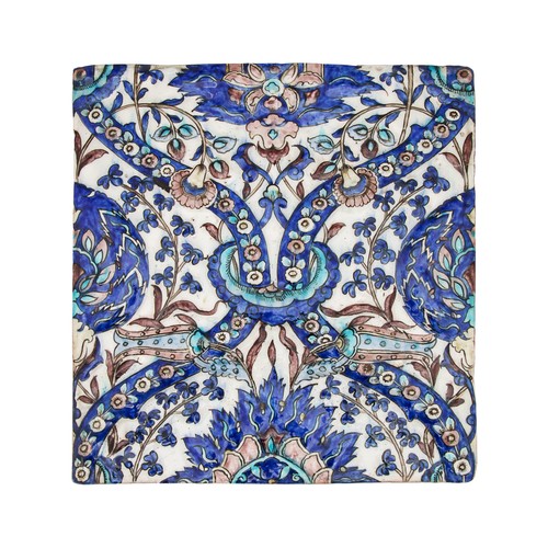 473 - Persian, Qajar19th CenturyA moulded tile with mixed tulips and arches, the background white with fol... 