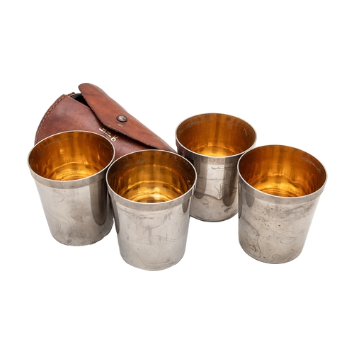 497 - 20th CenturyA group of four silver-plated beakers in leather case and seven various small glass cand... 