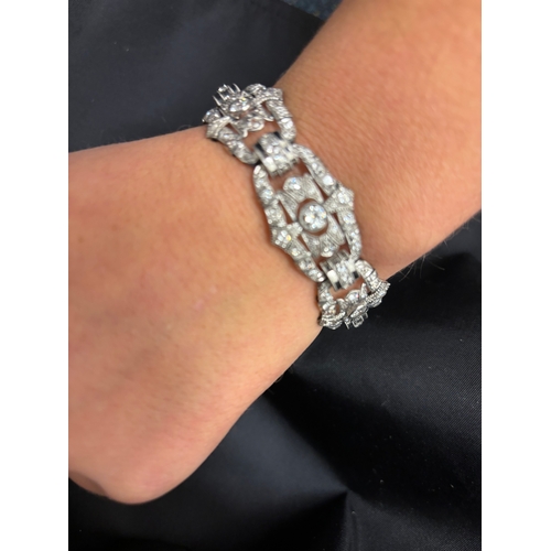 62 - Art DecoA diamond and platinum braceletComprising seven architectural style panels with larger centr... 