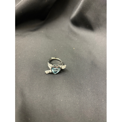 71 - A blue topaz and diamond arrow heart ringThe heart shaped centre with rub over setting with tapered ... 