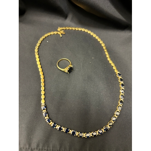 76 - Circa 1980A sapphire, diamond, and gold necklace and ringComprising 22 uniform size oval sapphires w... 