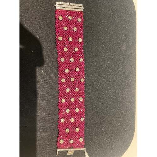 104 - A ruby and diamond braceletComposed of a wide mesh of faceted ruby beads applied with rose cut diamo... 