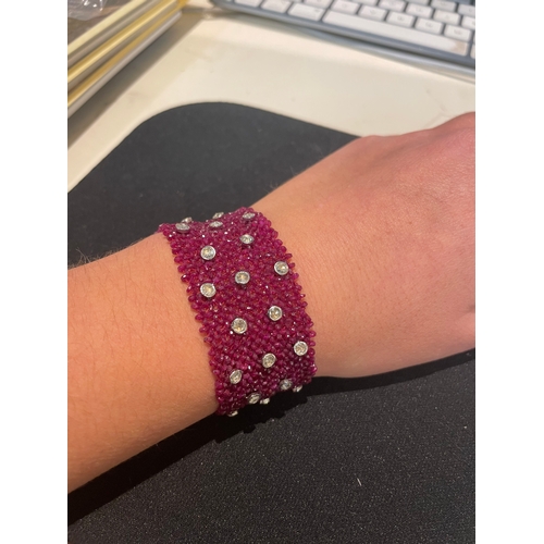 104 - A ruby and diamond braceletComposed of a wide mesh of faceted ruby beads applied with rose cut diamo... 