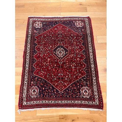 291 - An intricately geometric patterned rug, on a red field, the reverse with Harout Barin labelsProperty... 