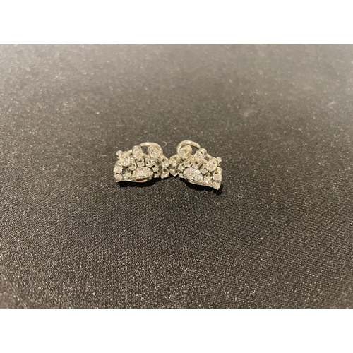 90 - Circa 1930A pair of diamond cluster earringsDesigned as a cornucopia scroll and set throughout with ... 