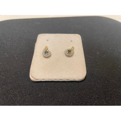 93A - A pair of sapphire and cluster diamond earrings mounted in yellow gold.