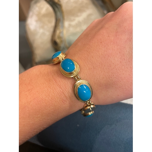 97 - A fine turquoise and 14 carat yellow gold braceletComprising eight graduated oval turquoise in yello... 