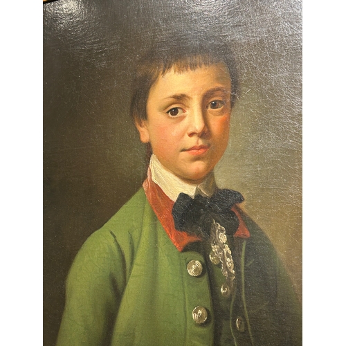 346 - Attributed to Sir Nathaniel Dance-Holland (1735 - 1811)Portrait of a boy in green coat in a feigned ... 