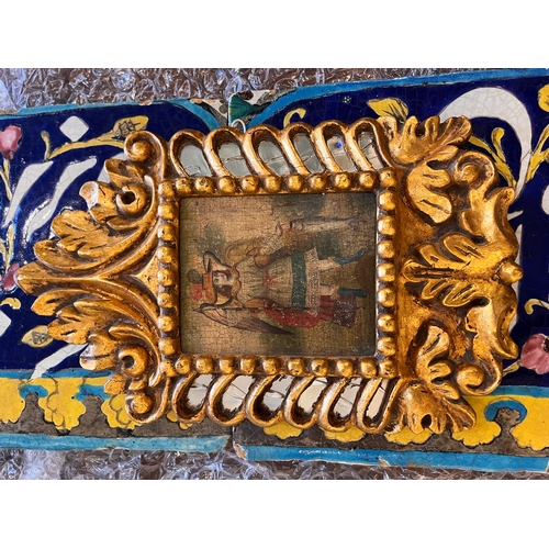 524 - Cuzco SchoolTwo paintings and a mirror, [a] one of an angel with a fish, the other of a [b] pious bo... 