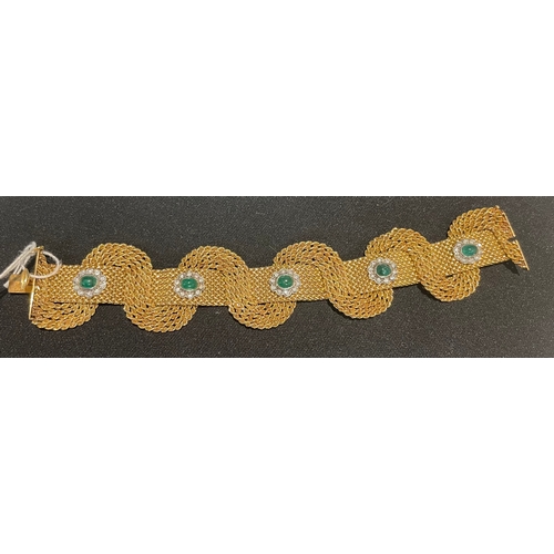 94 - Circa 1950An attractive 18 carat gold interwoven mesh emerald and diamond set braceletThe interwoven... 