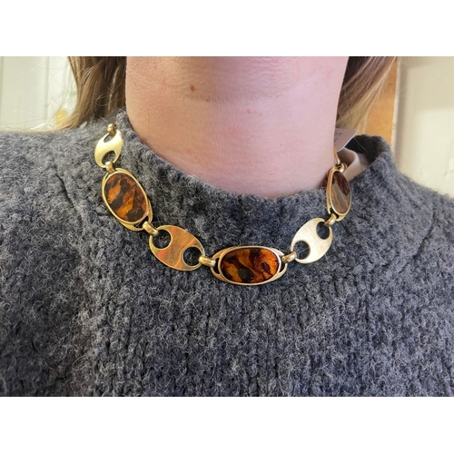 95 - Circa 1970A gold and faux tortoiseshell enamel necklace and braceletThe necklace comprising six oval... 