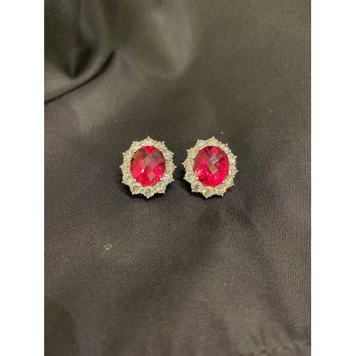 84 - An impressive pair of pink tourmaline and brilliant cut diamond cluster earringsThe oval briollete p... 