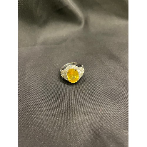 85 - A yellow sapphire and diamond cocktail dress ringThe oval shaped mixed cut yellow sapphire of good c... 