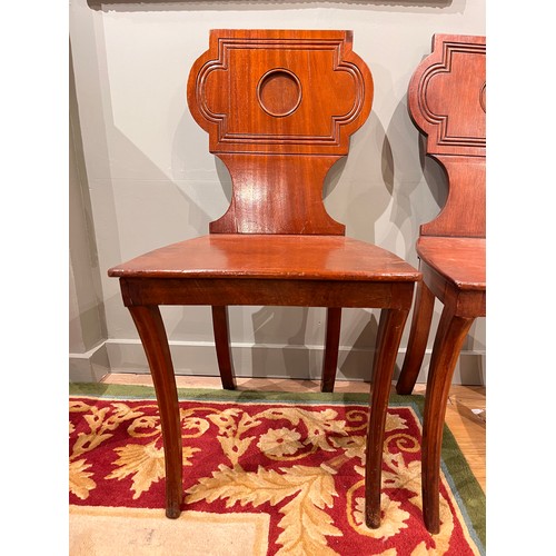 255A - Late 19th/ Early 20th centuryA pair of mahogany hall chairsWith carved detail to the backsDimensions... 