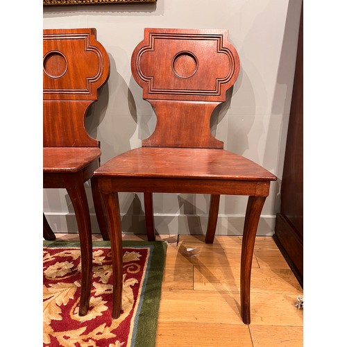 255A - Late 19th/ Early 20th centuryA pair of mahogany hall chairsWith carved detail to the backsDimensions... 