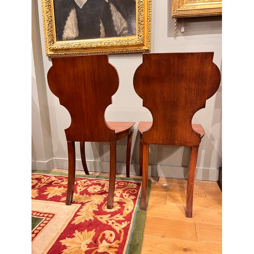 255A - Late 19th/ Early 20th centuryA pair of mahogany hall chairsWith carved detail to the backsDimensions... 