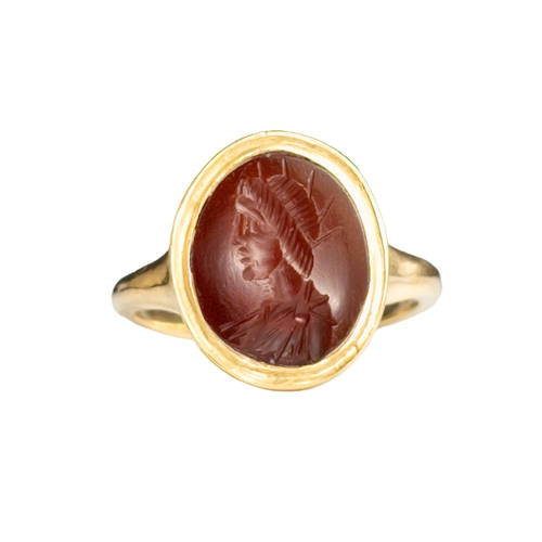 54 - A Roman carnelian intaglio of a young Emperor wearing a radiating crownSet in a modern 18ct gold rin... 