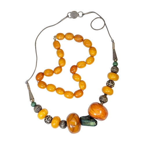 98 - [a] South East AsianCirca 1920An amber and silver coloured metal necklace[b] South East AsianCirca 1... 