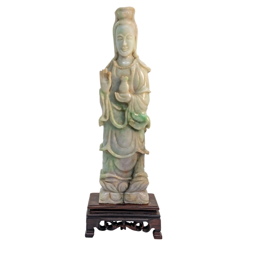 118 - ChineseCirca 1920A jadeite figure of Guan YinMounted on a carved hardwood baseDimensions: (Figu... 