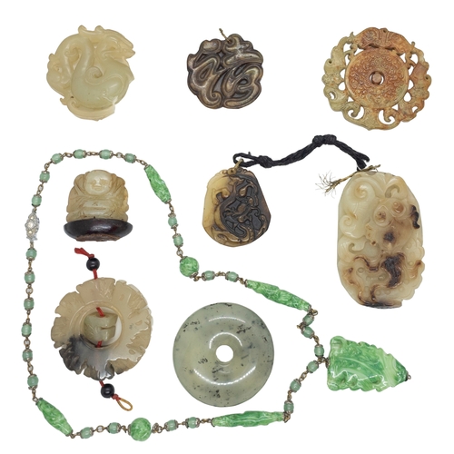 122 - Chinese20th CenturyA group of jade and jadeite pendantsComprising of nine pendants, including a neph... 