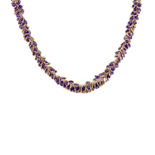 94 - EuropeanContemporaryAn Amethyst and yellow 14 carat gold fringe necklace The amethysts spectacle set... 