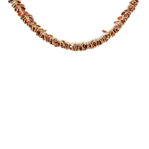 96 - EuropeanContemporaryA pretty garnet and 14 carat yellow gold fringe necklace set throughout with spe... 