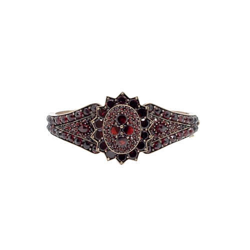 26 - Bohemiancirca 1880An antique garnet cluster bangleWeight:Approx: 23gramsDimensions:Approx: (wrist me... 
