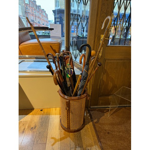 170A - A wicker umbrella stand, with umbrellas and sticks