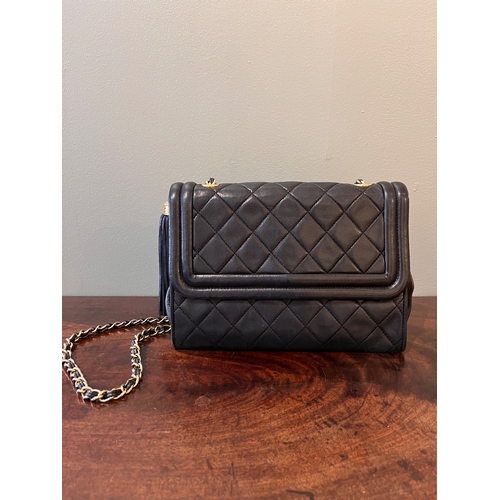 13 - ChanelVintageA black quilted leather tassel flap bagWith Chanel card of authenticity Dimensions... 