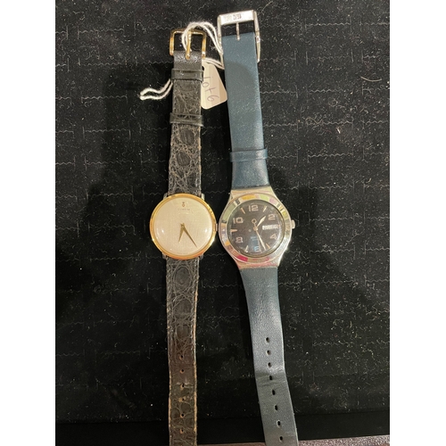 6 - Swiss Circa 1950,[a] Corum, A slim line two coloured metal wrist watch on leather strap.[b] A swatch... 