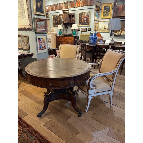 221 - 19th CenturyA drum table with embossed and gilt leather top. Tapering octagonal faceted column onto ... 