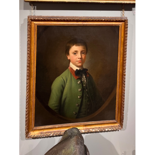 258 - Attributed to Sir Nathaniel Dance-Holland (1735 - 1811)Portrait of a boy in green coat in a feigned ... 