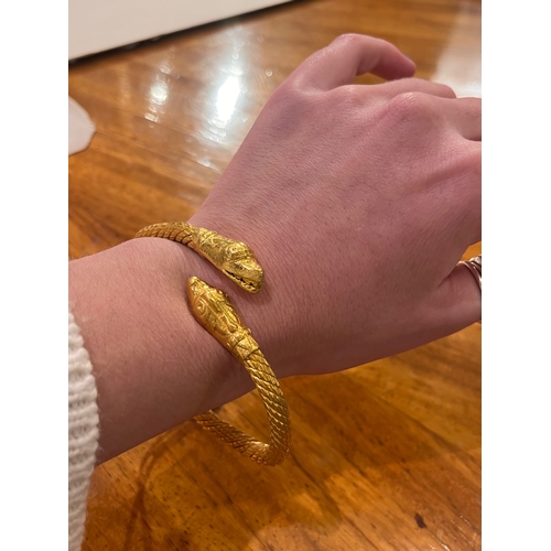 10A - Middle Eastern circa 1890A heavy high carat yellow gold snake Torq bangleTotal weight:Approx 105 gra... 