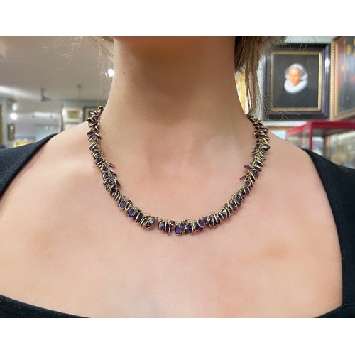 94 - EuropeanContemporaryAn Amethyst and yellow 14 carat gold fringe necklace The amethysts spectacle set... 