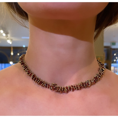 96 - EuropeanContemporaryA pretty garnet and 14 carat yellow gold fringe necklace set throughout with spe... 