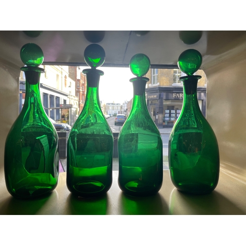 459 - 20th CenturyFour handblown green glass bottles with stoppersProperty of a noblemanDimensions:13 in. ... 